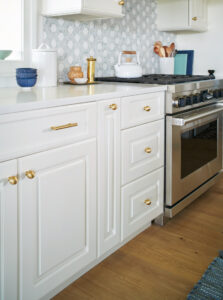nautical kitchen on severn river with ivory cabinets, hexagon tile, gold hardware renovation by mueller homes