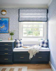nautical navy blue window seat built-in with blue wallpaper